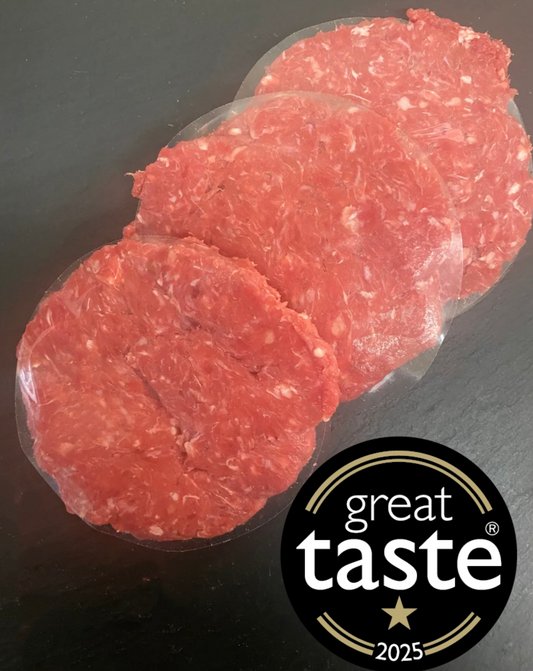 Raw ground beef slices on a black surface with a 'Great Taste' 2025 award logo.